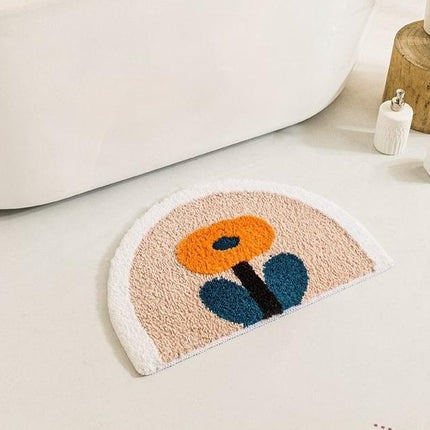 Półokrągły dywanik z pomarańczowym kwiatem